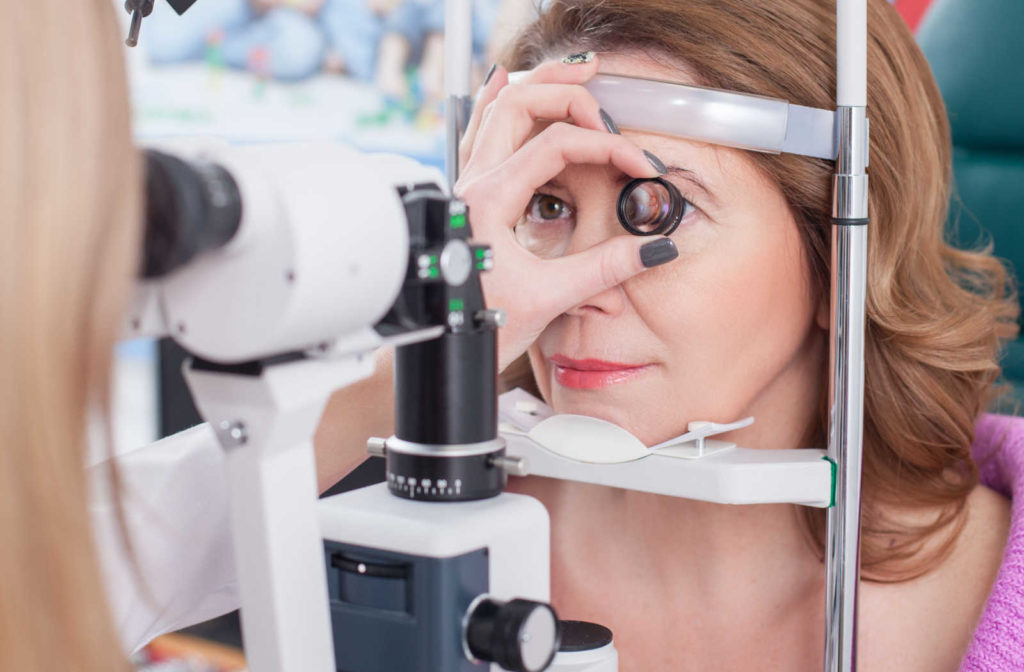 A woman having her eyes examined by an optometrist to prevent vision issues.