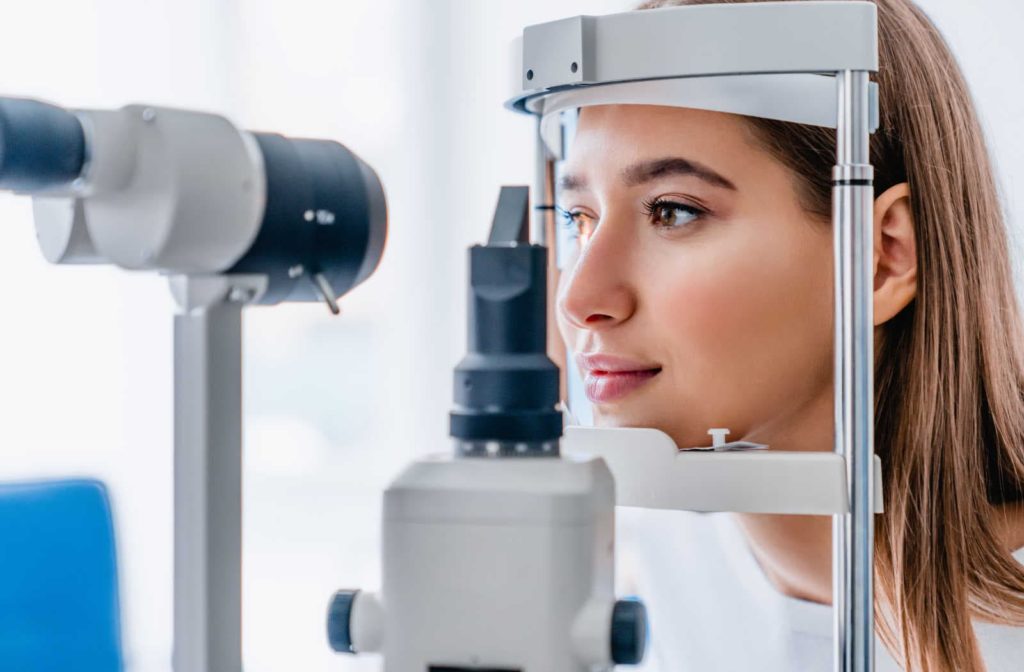 A patient having her eyes examined during a comprehensive eye exam