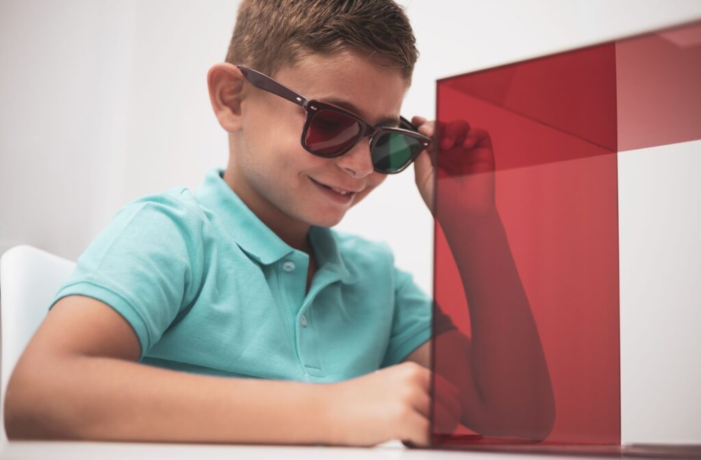 A young child wearing special lenses doing a prism exercise to help with binocular vision dysfunction.