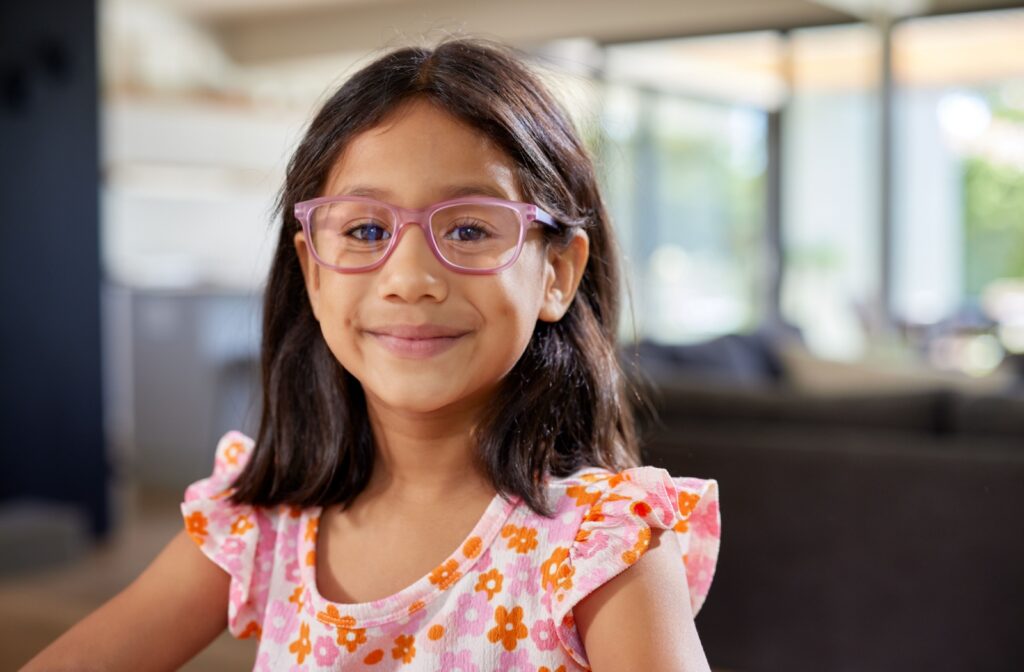 A happy child wears myopia eyeglasses.