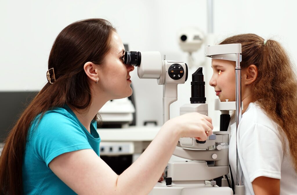 A young child getting a slit lamp eye test during an annual eye exam